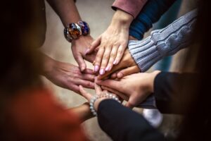 Various hands meeting together in a circle
